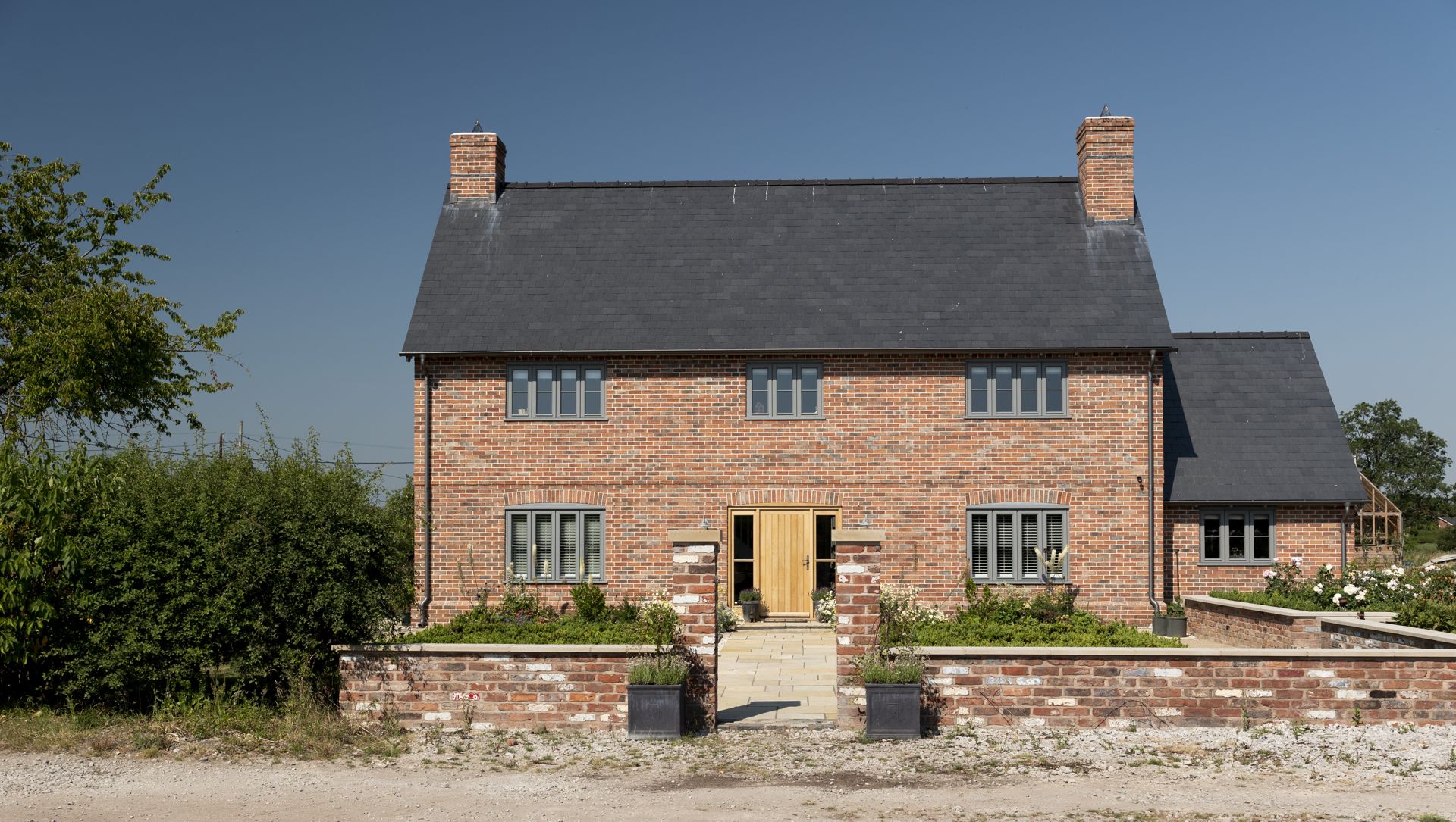 Red brick country house with chimneys